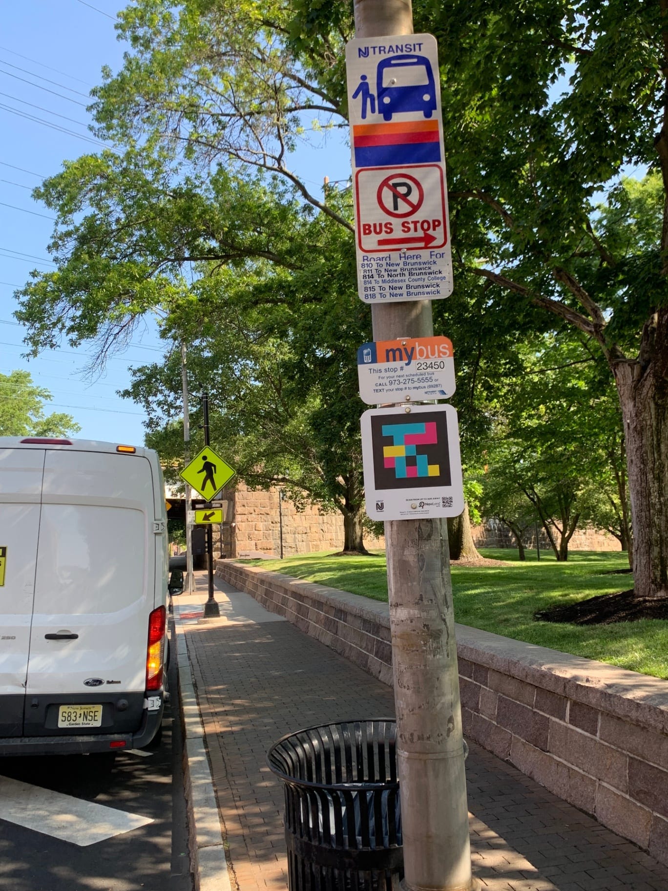 NJ TRANSIT pole with mybus stop #23450 sign and NaviLens code, next to the Rutgers campus in New Brunswick (NJ)